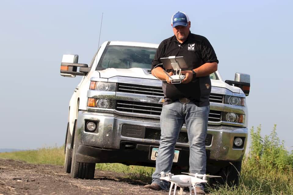 A DreamDirt representative works with a drone.