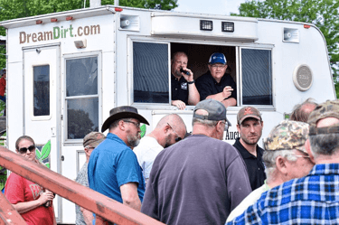 DreamDirt auctioneers call out from a DreamDirt RV.