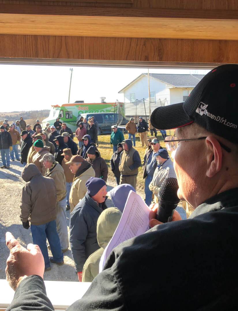 crowd at auction with auctioneer selling